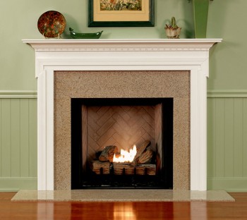 Granite facing kit shown with a fireplace mantel with dentil molding underneath the top shelf.