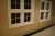 Typical Classic American Flat Panel Wainscoting used on a wall with windows.  We are happy to customize the design and cut the components at our factory for your wainscot project!