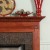 Neatly designed block trim and dentil molding are enhancers for the wood fireplace mantel.