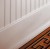Closeup image of Classic Beadboard, baseboard and shoe molding painted white.